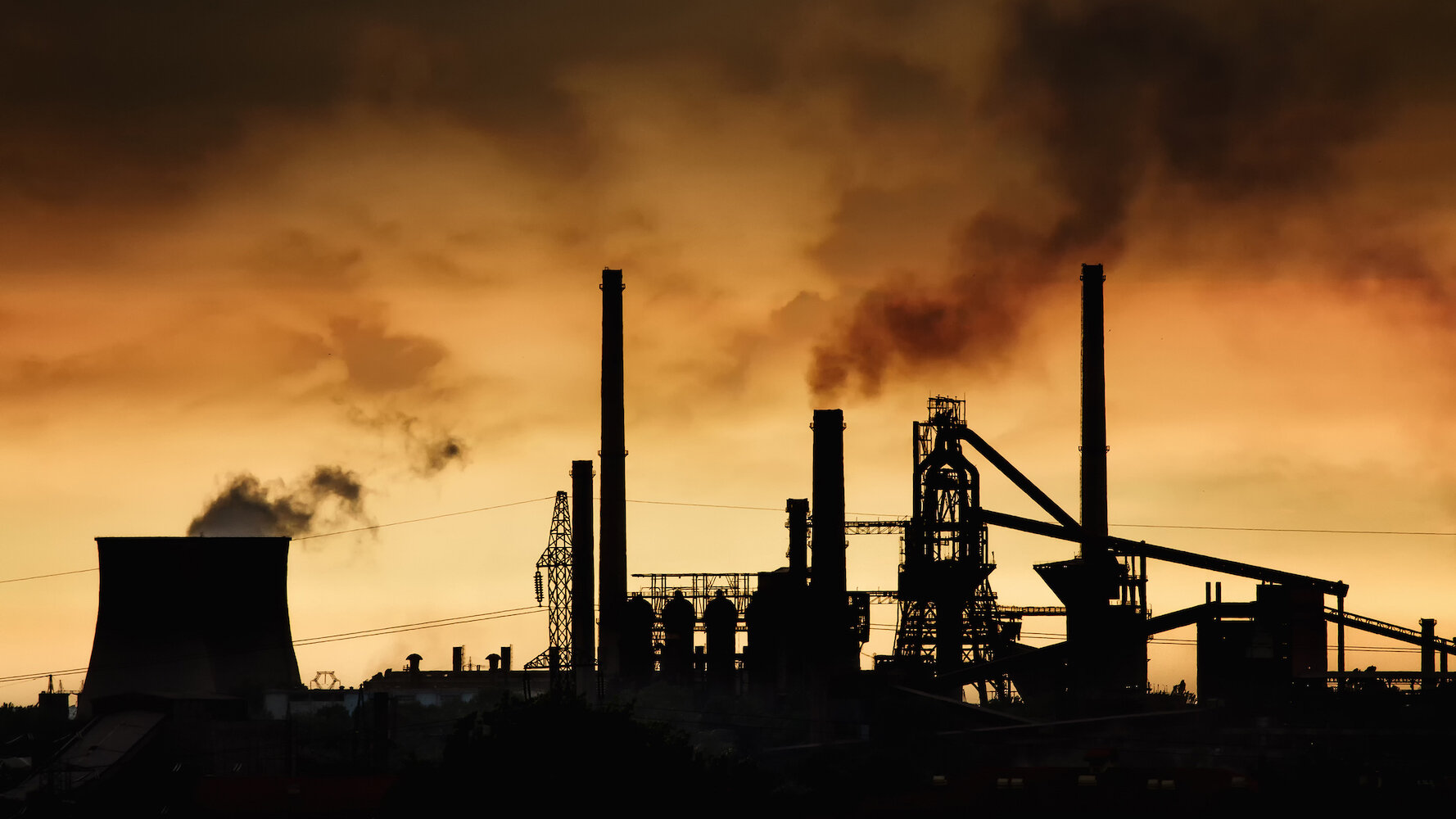 Smokestack,In,Factory,With,Yellow,Sky,And,Clouds.,Industrial,Pollution.